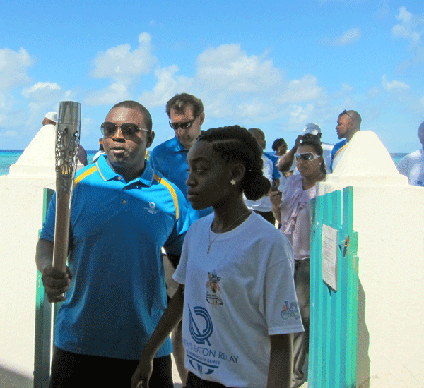 Nickson Dickenson, Deputy Youth Director TCI Government hands off the baton to  De’Ajah Smith, Inter-Island Champion  
